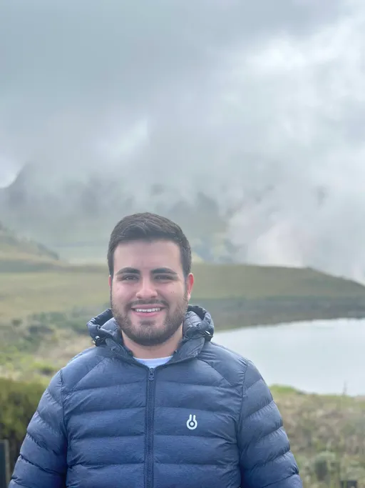 Simón Marín in the mountains near a lake